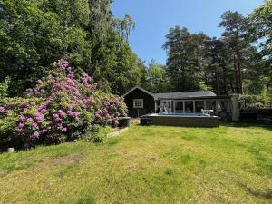 a house with a swimming pool in a yard at Beautiful and private with heated pool & hot tub in Ljungbyhed