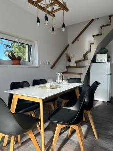 a dining room with a table and black chairs at Relax House Mšené-lázně in Loucká +18 photos