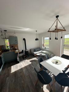 a living room with a table and chairs and a couch at Chata Mšené-lázně - Vrbice in Loucká +13 photos