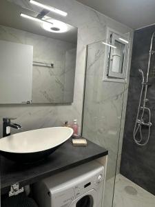 a bathroom with a sink and a shower at JOHNMAR apartment in Athens