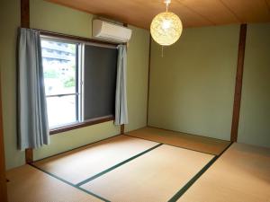 Ένα ή περισσότερα κρεβάτια σε δωμάτιο στο 関西空港近く- JR日根野駅前 The Palm guest house