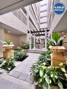 an empty lobby with plants in a building at Luxury Studio Stay at Saint Dominique in Mandurriao