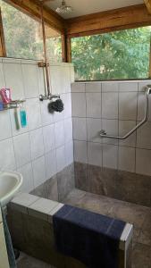 a bathroom with a shower and a sink at Proudly Okavango self-catering Burnside in Shakawe