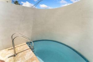 a hot tub in the corner of a building at Casa Loba Luxe Unit 2 with private pool and garden in Rincon