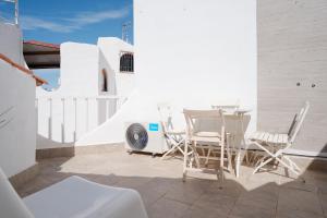 a patio with a table and chairs on a balcony at Las Tortugas Bungalow Beach in Arona