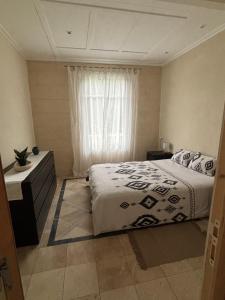 une chambre avec un grand lit et une fenêtre dans l'établissement Maison Colibri, à Salies-de-Béarn