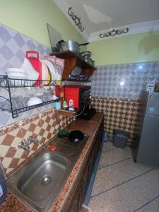 a kitchen with a sink and a counter top at Tayoukhte Surf Camp Imsouane in Imsouane +18 photos