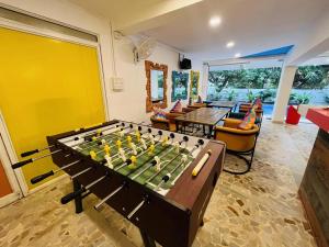 a living room with a foosball table and chairs at goSTOPS PLUS Goa, Vagator in Goa Velha