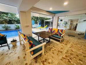 a living room with a table and chairs at goSTOPS PLUS Goa, Vagator in Goa Velha