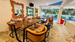 a dining room with a table and chairs at goSTOPS PLUS Goa, Vagator in Goa Velha +35 photos