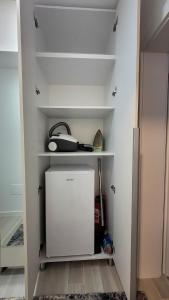 a closet with a small white cabinet in a room at Modern Studio Craiova in Craiova