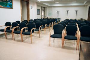 a room with a row of chairs in a classroom at Hotel Dastan Aktobe in Aktobe