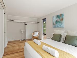 a white bedroom with a large bed and a window at Wren Studio - Private One-Bedroom Studio Nestled in Bushland in Yallingup