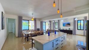 a kitchen and living room with a table and chairs at Sosua Ocean Village - Villas Marinas 27B in Sosúa