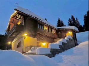 a log house in the snow at night at Holiday home in Campo Carlo Magno 24162 in Madonna di Campiglio