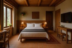 a bedroom with a bed and two tables and a television at Serokan The Anami in Cai Be