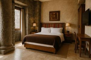 a bedroom with a bed and a desk and a window at Serokan The Anami in Cai Be