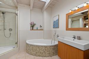 a bathroom with a tub and a sink at Svyvo Cologne-Esch Design Apartment in Cologne