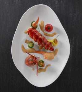 a white plate of food on a table at une terrasse en ville in Langon
