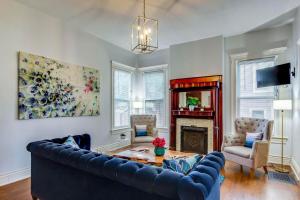 a living room with a blue couch and a fireplace at 6br New Orleans Speakeasy Hot Tub & Playground in Louisville