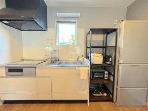 a kitchen with a sink and a refrigerator at OKINAWA POOLWILLA ONNA 4A - Vacation STAY 48422v in Baba