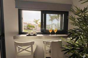a dining room with two chairs and a window at Ecoloft Aldea in San Miguel de Abona
