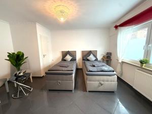a hospital room with two beds and a window at Apartment Mira 12 in Pulheim