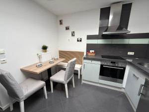 a kitchen with a table and chairs and a stove at Apartment Mira 12 in Pulheim