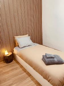 a bed with a towel on it in a room at Janelas do Governador in Elvas