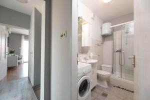 a white bathroom with a washing machine in it at Apartment in Crikvenica 41694 in Sopaljska +15 photos