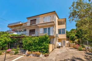 an apartment building with balconies and a driveway at Apartment in Crikvenica 41694 in Sopaljska