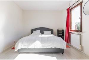 a white bedroom with a large bed and a window at Day To Day Motel in Ludvika +18 photos