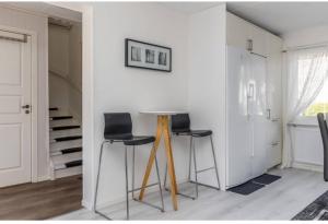 a dining room with two chairs and a table at Day To Day Motel in Ludvika