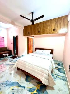 a bedroom with a large bed in a room at Radhika Residency in Perintalmanna +4 photos