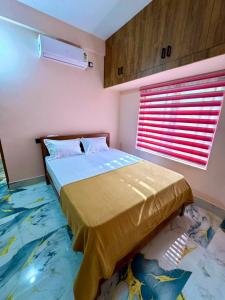 a bedroom with a bed and a window at Radhika Residency in Perintalmanna