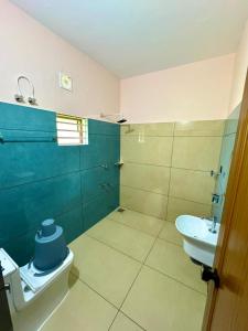 a bathroom with a toilet and a sink at Radhika Residency in Perintalmanna