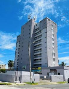 a tall gray building with a cross on top at The Sandy Pearl Apartment in Luquillo