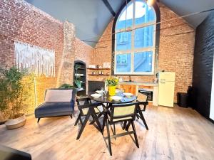 a kitchen and dining room with a table and chairs at NEW Central old town - Exclusive Residences in Antwerp