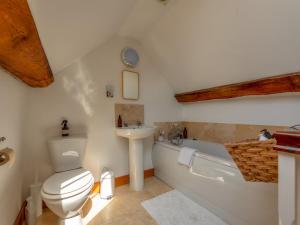 a bathroom with a toilet and a sink at Pass the Keys Charming Granary Escape Garden Countryside in Much Wenlock