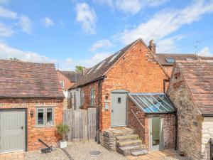 an image of a brick house with a garage at Pass the Keys Charming Granary Escape Garden Countryside in Much Wenlock