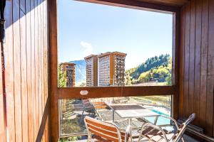 a view from a balcony with a table and chairs at Notre Petite Famille - Station Le Corbier in Villarembert