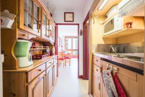 a kitchen with wooden cabinets and a green appliance at Notre Petite Famille - Station Le Corbier in Villarembert +7 photos