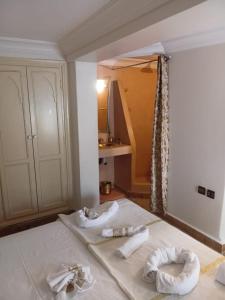 a room with two beds with towels on them at Riad Le Bijou de Zahra Marrakech Kasbah in Marrakech