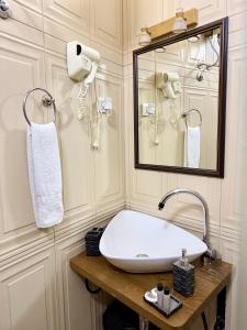 a bathroom with a sink and a mirror at Hotel Fjor in Prizren