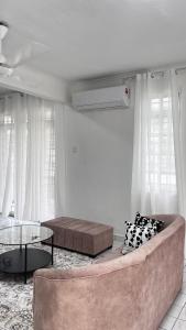 a living room with a couch and a table at Anggun's palace in Pasir Gudang