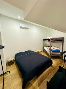 a bedroom with a bed and a shelf at L escapade de l'Ancien Rail in Pouilly-sous-Charlieu +3 photos