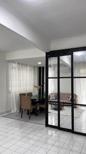 a living room with a table and a couch at Anggun's palace in Pasir Gudang