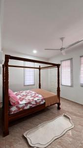 a bedroom with a bed and a rug on the floor at Anggun's palace in Pasir Gudang