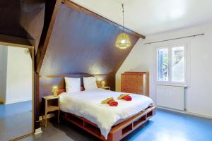 a bedroom with a large bed with a wooden headboard at La Gardère - Villa Sarlat in Sarlat-la-Canéda +21 photos