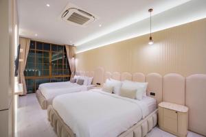 Postel nebo postele na pokoji v ubytování Paco Villa Pattaya + 76 fotografií